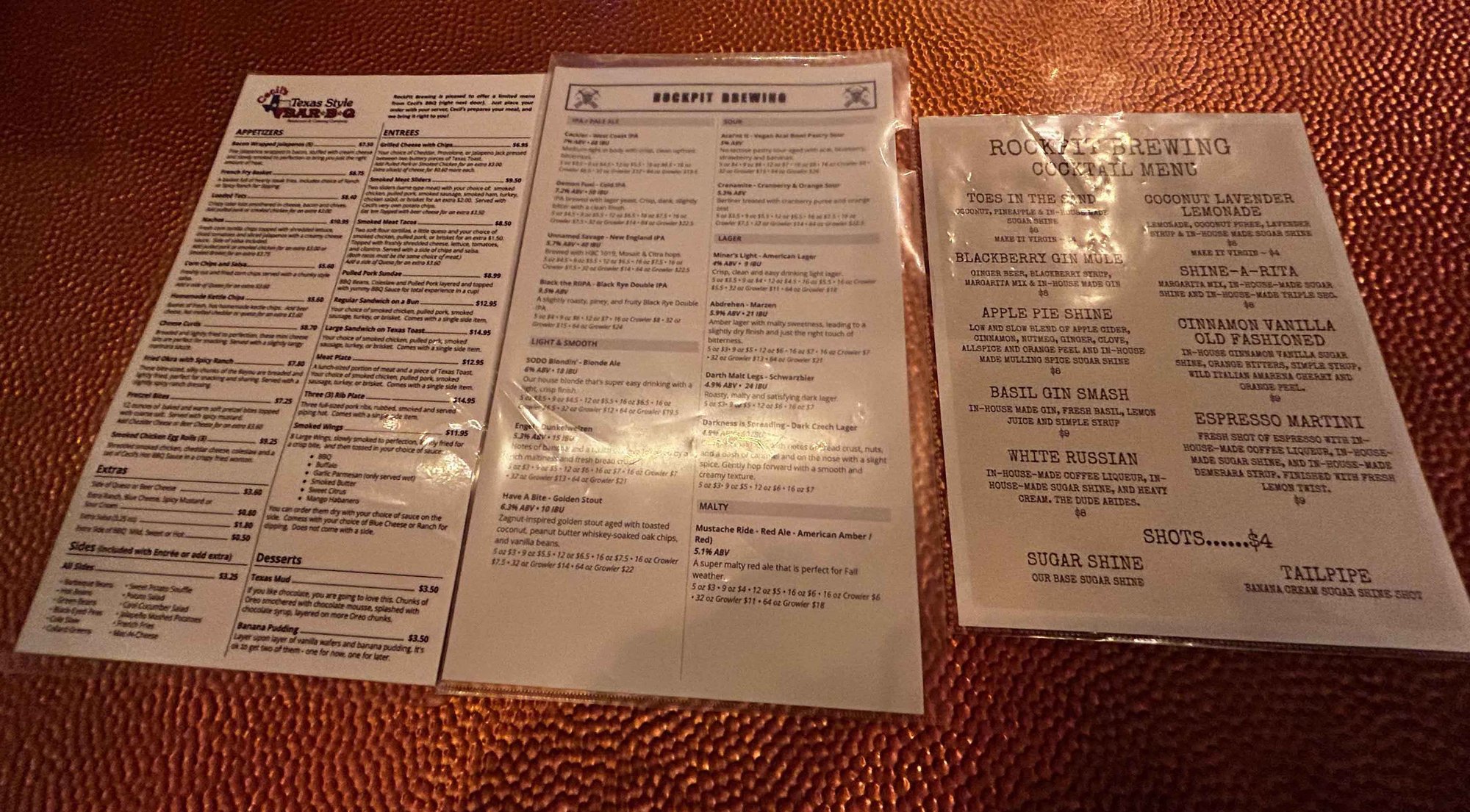 three white laminated menus with lists of items